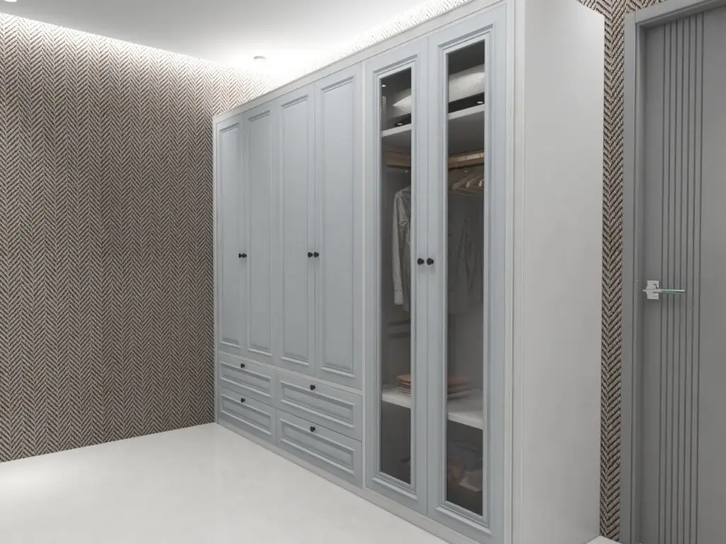 Spacious walk-in wardrobe with built-in cabinets and lighting.